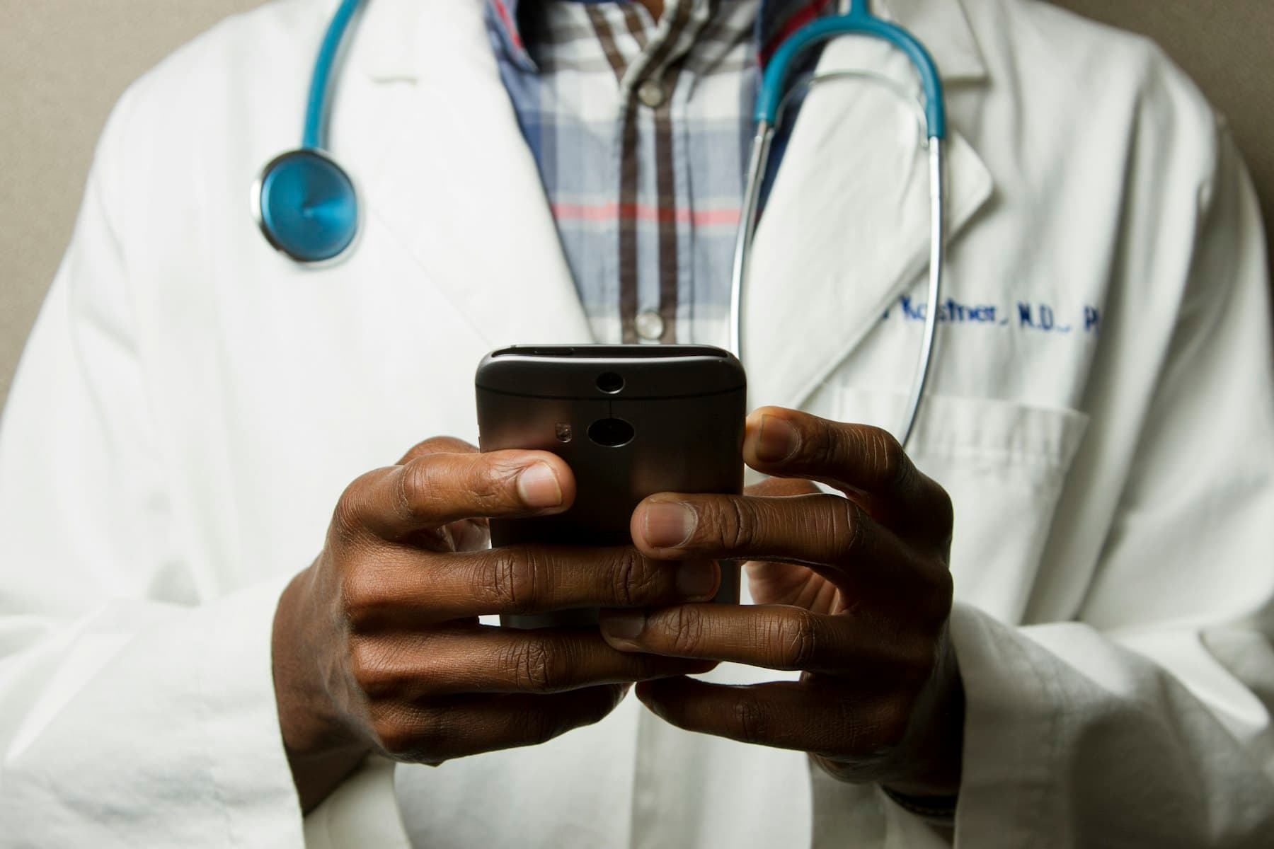A doctor listening to a patient's abdomen during an examination